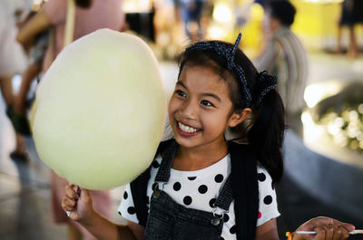 Close-up of girl holding cotton candy