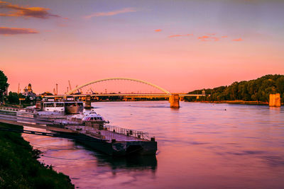 View of bridge over river at sunset