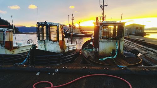 Ship in city against sky during sunset