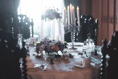  flowers in vase on table with light coming through window