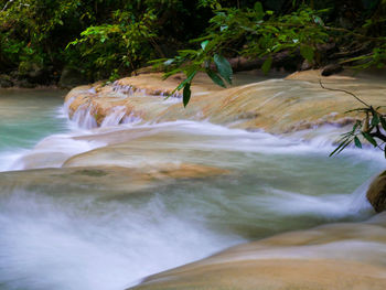 Close-up of waterfall along river