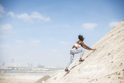 Woman on beach against sky