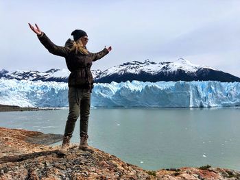 Full length of woman looking at glaciers during winter