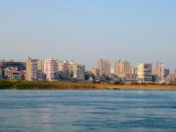 Scenic view of sea and buildings against sky