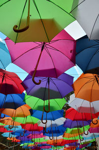 Opened colorful umbrellas with a part of blue sky with clouds