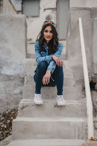 Portrait of woman sitting on staircase