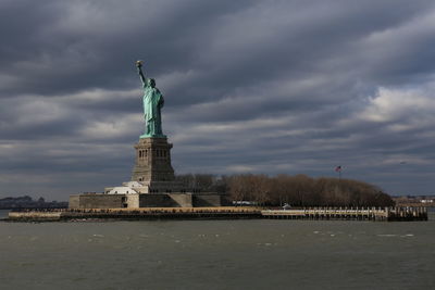 Statue of liberty against cloudy sky