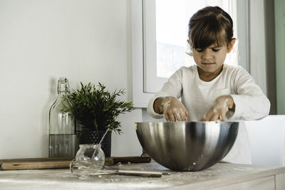 Boy looking at camera on table at home