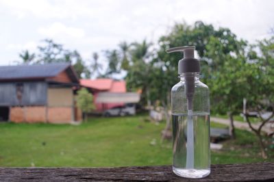 Bottle on table against sky