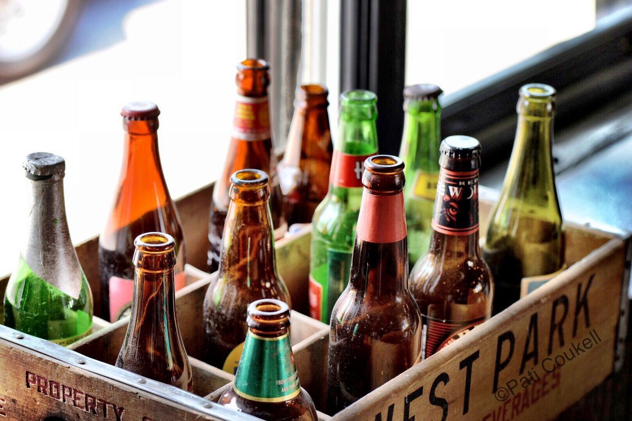 indoors, variation, still life, bottle, arrangement, glass - material, choice, table, close-up, large group of objects, side by side, in a row, focus on foreground, drink, multi colored, jar, no people, collection, transparent, text