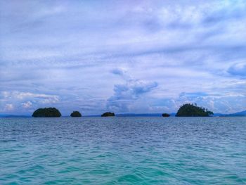 Scenic view of sea against cloudy sky