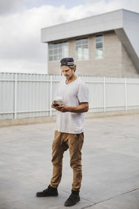 Full length of man standing against building