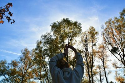 Low section of man against trees against sky