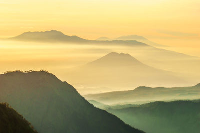 Scenic view of silhouette mountains against sky during sunset