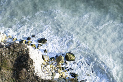 High angle view of rocks in sea