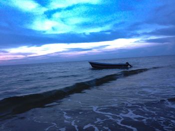 Scenic view of sea against cloudy sky