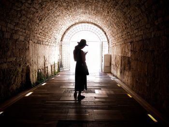 Woman standing on cobblestone
