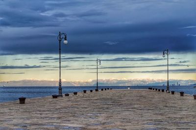 View of calm sea against dramatic sky