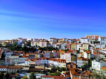 High angle shot of townscape against blue sky