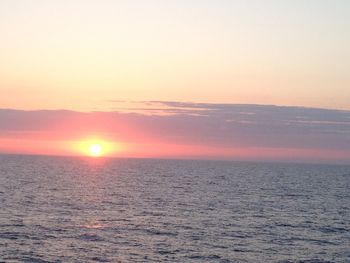 Scenic view of sea against romantic sky at sunset