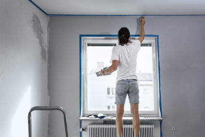 Man painting walls at home