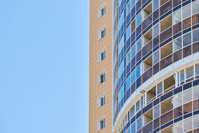 Low angle view of modern building against clear blue sky