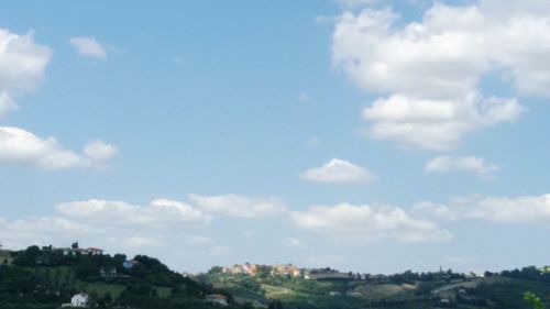 View of residential district against cloudy sky