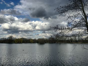 Scenic view of river against cloudy sky