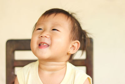 Portrait of cute boy looking away at home