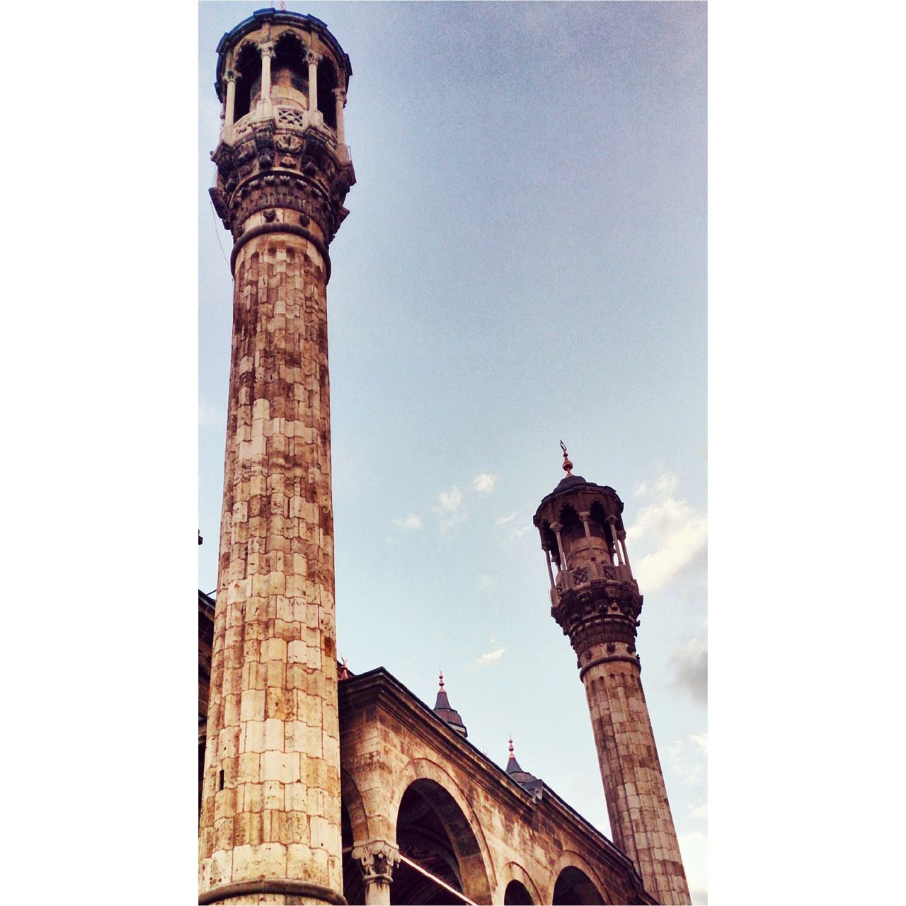 low angle view, architecture, built structure, clear sky, one animal, animal themes, building exterior, copy space, history, sky, high section, tower, arch, no people, day, outdoors, statue, animals in the wild, wildlife, bird