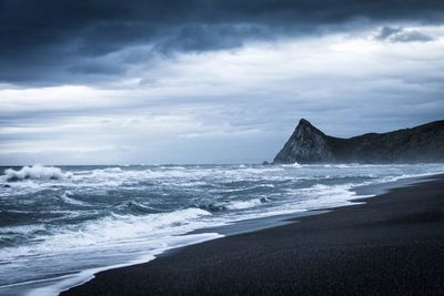 Scenic view of sea against cloudy sky