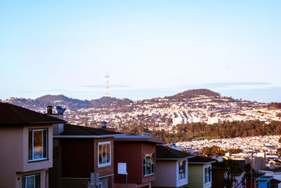 Buildings in town against clear sky