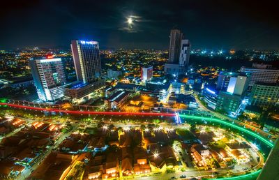 High angle view of illuminated city buildings at night