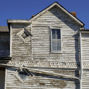 Low angle view of houses against blue sky