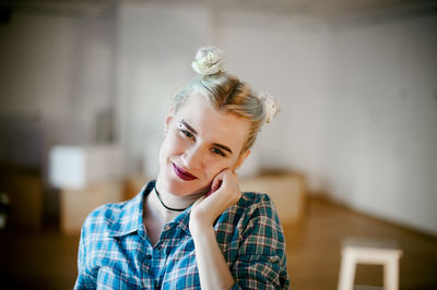 Close-up of portrait of smiling young woman at home