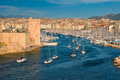 Yachts coming to marseille old port on sunset. marseille, france