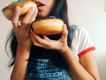 Teenage girl eating donuts