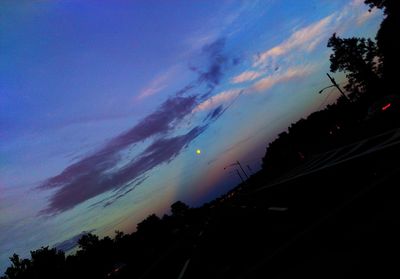 Silhouette of trees against sky at dusk