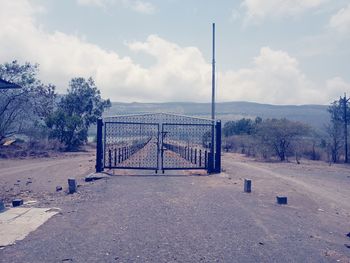 View of bridge in field against sky