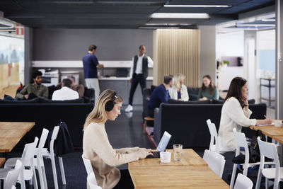 Woman working solitary in office cafeteria