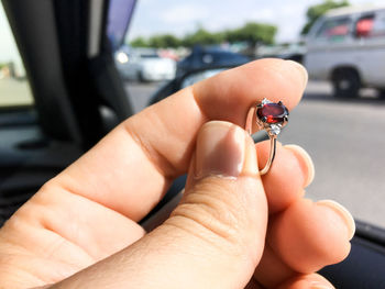 Close-up of hand holding small car