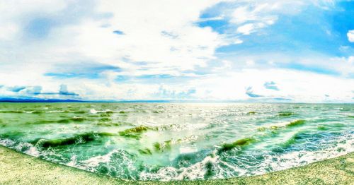 Scenic view of sea against cloudy sky