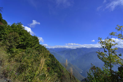 Scenic view of mountains against blue sky