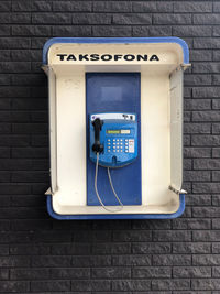 Close-up of telephone booth on wall