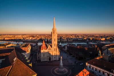 View of tower in city against clear sky