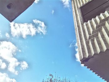 Low angle view of trees against blue sky