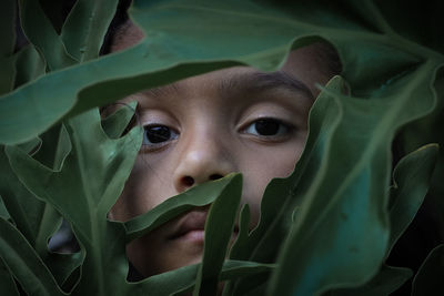 Close-up portrait of cute  girl with leaves 