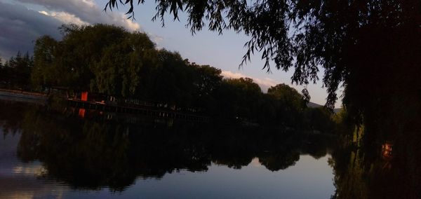 Scenic view of lake against sky at dusk