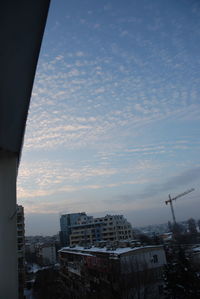 Buildings against cloudy sky