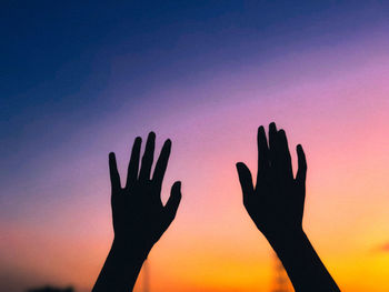 Silhouette person against sky during sunset